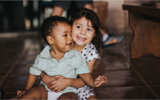smiling siblings